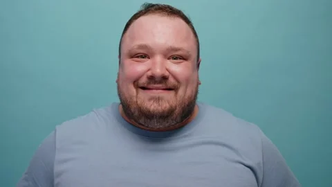 Close-up of a man showing emotions at camera on a blue background Stockbeeldmateriaal 237548971