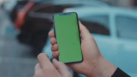 Close-up man showing greenscreen of vertical mock-up mobile phone staying in the Stock Footage 117425976