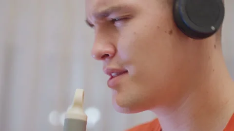 Close Up Of Man Singing With Mop Handle As Microphone Wearing Headphones Stock Footage 319917915