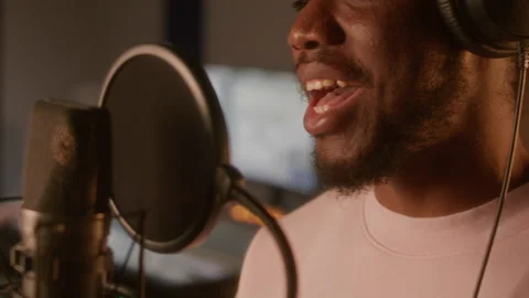 Close Up of Man Singing into Professional Microphone during Recording Session 库存影片 334375536