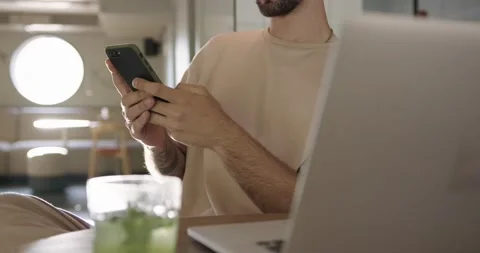 Close up of man sitting at cafe with smartphone and laptop Video stock 159082280