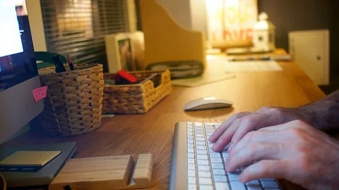 Close-up of a man sitting at the desk and typing on the keyboard Stock Footage 98957929