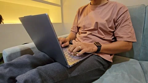 Close Up man sitting on sofa using laptop Stock Footage 288943983
