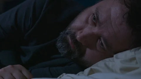 Close man sleeps and opens his eyes Stock Footage 120730408