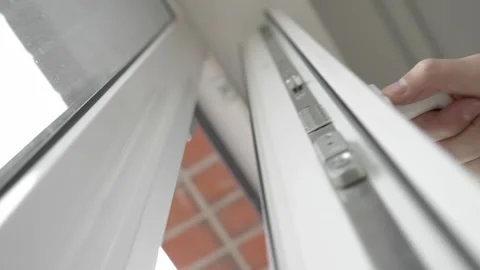 Close-up of a man slightly opens the window to ventilate, letting in fresh air. Stock Footage 255117782