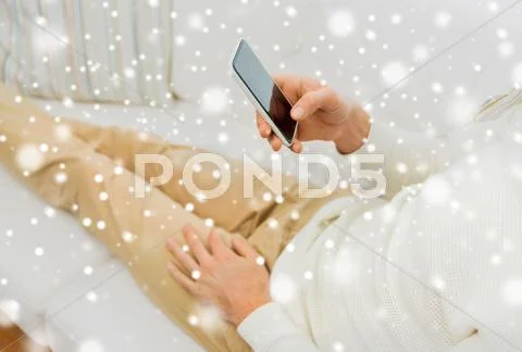 Close up of man with smartphone at home Stock Photos