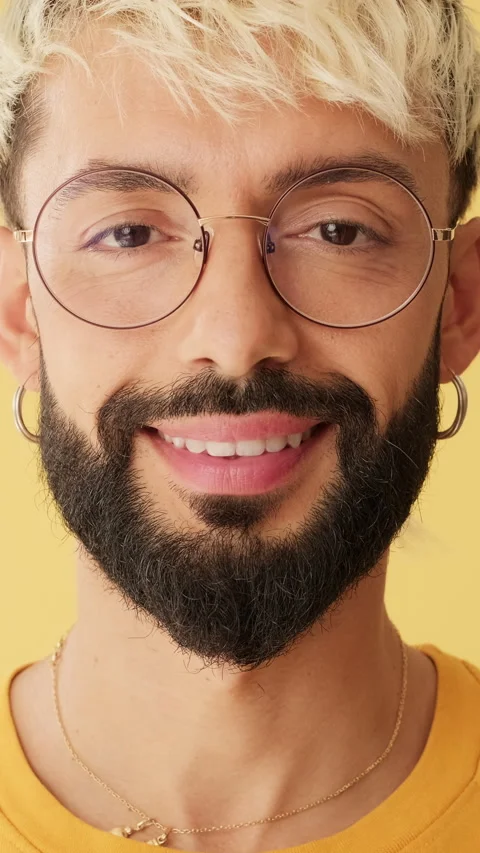 Close-up, man smiling looking at camera isolated on yellow background in studio Stock Footage 258808258
