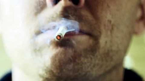 Close up of a man smoking a cigarette Stock Footage 61087810