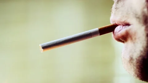 Close up of a man smoking a cigarette Stock Footage 61087913