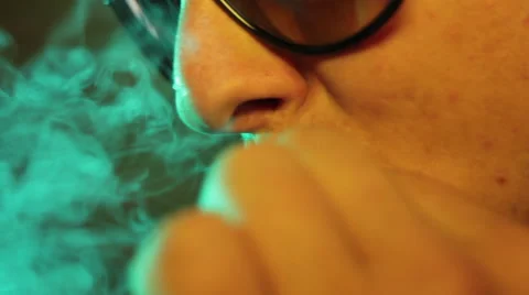 Close up of a man smoking a joint Stock Footage 56965933