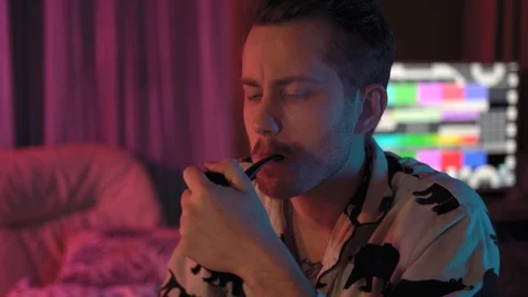 Close-up of a man Smoking a pipe.a man with a mustache and stubble Stock Footage 128459064