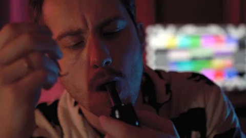 Close-up of a man Smoking a pipe.a man with a mustache and stubble Stock Footage 128459593