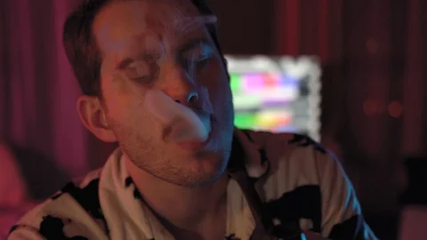 Close-up of a man Smoking a pipe.a man with a mustache and stubble Stock Footage 128459796