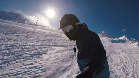 Close up man snowboarder shooting himself on a gopro waving his hand in the Video stock 124044166