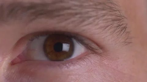 Close-up of a man squinting his eye with focus and determination Stock Footage 294080485