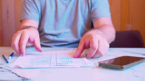 Close-up of man stacking paper documents and starting to write Stock Footage 336695087
