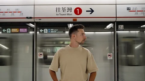 Close up of man standing at a modern subway platform in Hong Kong Stock Footage 297736786