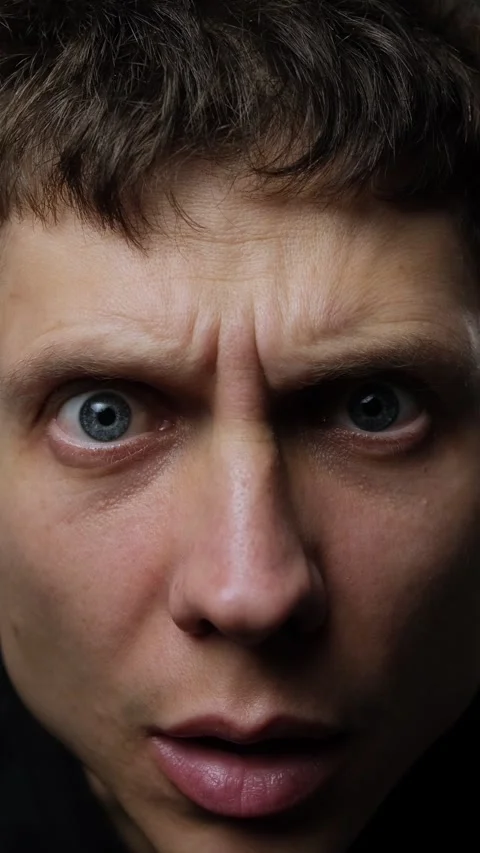 Close-up of man staring surprised into camera, concept of social media reaction Stock Footage 318066790