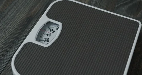 Close Up of a Man Stepping on a Scale Stock Footage 129347956