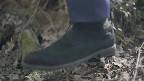 Close-up, man steps over a puddle in the forest. black shoes Stockbeeldmateriaal 195219387