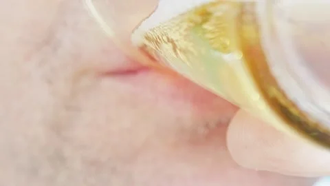 Close-up. A man with stubble drinks beer. Stock Footage 318602232