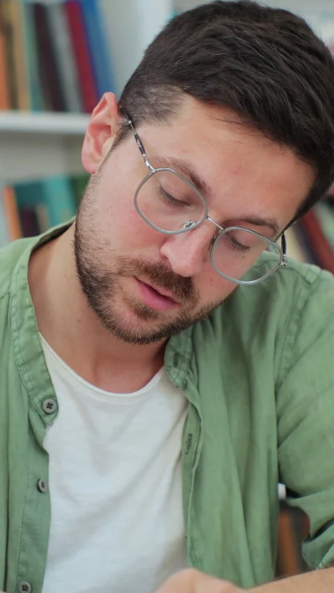 Close up man student reading book in university library. Stock Footage 345147208