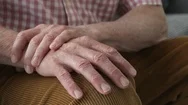 Close Up Of Man Suffering With Parkinsons Disease Holding Trembling Hand Stock Footage