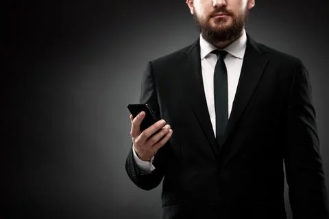 Close up of man in suit using smart phone Stock Photos