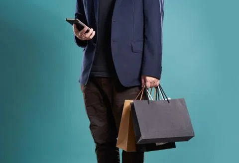 Close up of man  in suit using smartphone with shopping bags , isolated on li Stock Photos