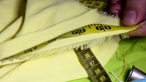 Close-up man tailor's hands are measuring a fabric Stock Footage 250485586