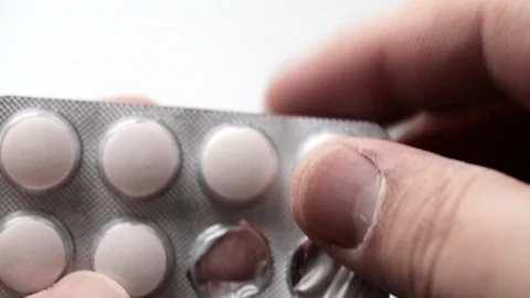 Close up of man takes white tablet or pill or drugs Stock Footage 89363564