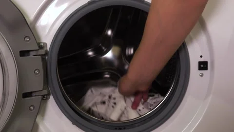 Close-up of a man taking clothes out of the washing machine Video stock 261756215