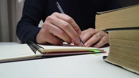 Close-up of a man taking notes on an agenda Stock Footage 146382763