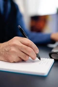 Close up of man taking notes on notebook Stock Photos