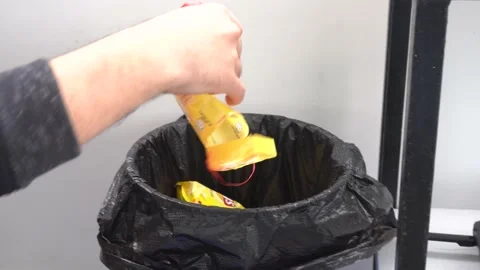 Close-up of a man taking out remains in the trash looking for something inside Stock Footage 155805918