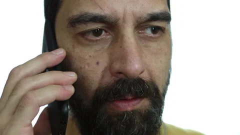 Close-up, a man talking on his cell phone on a white background Stock Footage 142152949