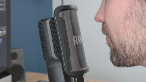 Close up of a man talking into a microphone for a podcast recording. Stock Footage 122748942