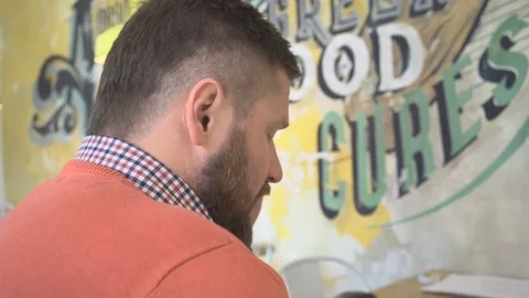 Close up, man talking by smartphone, profile shot, in cafe, steadicam Vídeo Stock 73292042