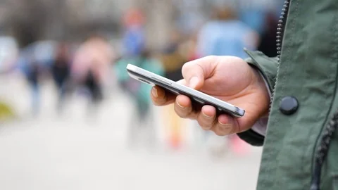 Close-up of a man tapping on his smartphone Stock Footage 97474912