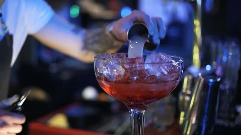 Close up of a man tending the bar making a cocktail 動画素材 79360098