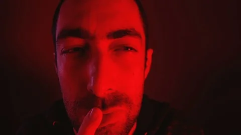 Close up on man with thoughtful facial expression with his finger to his lips Stock Footage 89971105