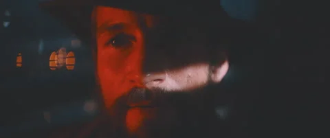 Close up of man through shutters and red lights using vintage camera Stock Footage 203568395