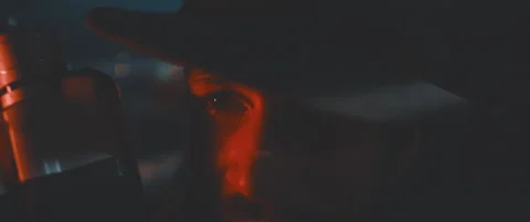 Close up of man through shutters and red lights using vintage camera Stock Footage 203568559