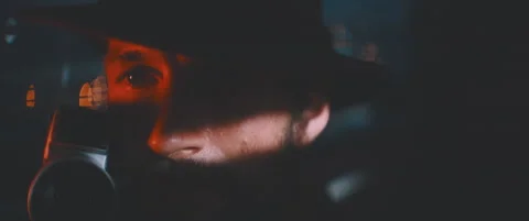 Close up of man through shutters and red lights using vintage camera Stock Footage 203568743