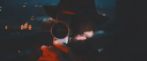 Close up of man through shutters and red lights using vintage camera Stock Footage 203568882