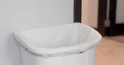 Close up of man throwing gloves in trash bin 動画素材 130672489