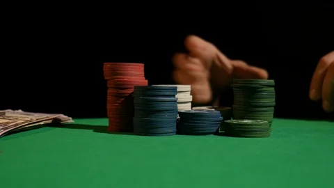 Close-Up of Man Throwing a Poker Chips in slow motion. Poker player increasing Stock Footage 87985768