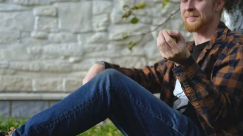 Close-up man throws an apple Stock Footage 200826094