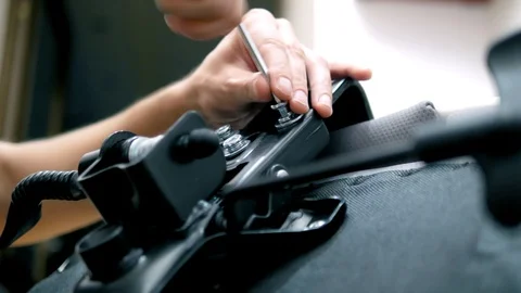 Close-up, the man tightens the screw with a hex wrench. Furniture assembly Stock Footage 107840221