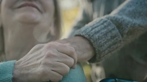 Close up of man touching hand of her wife which sitting on wheelchair Stock-Footage 208300382